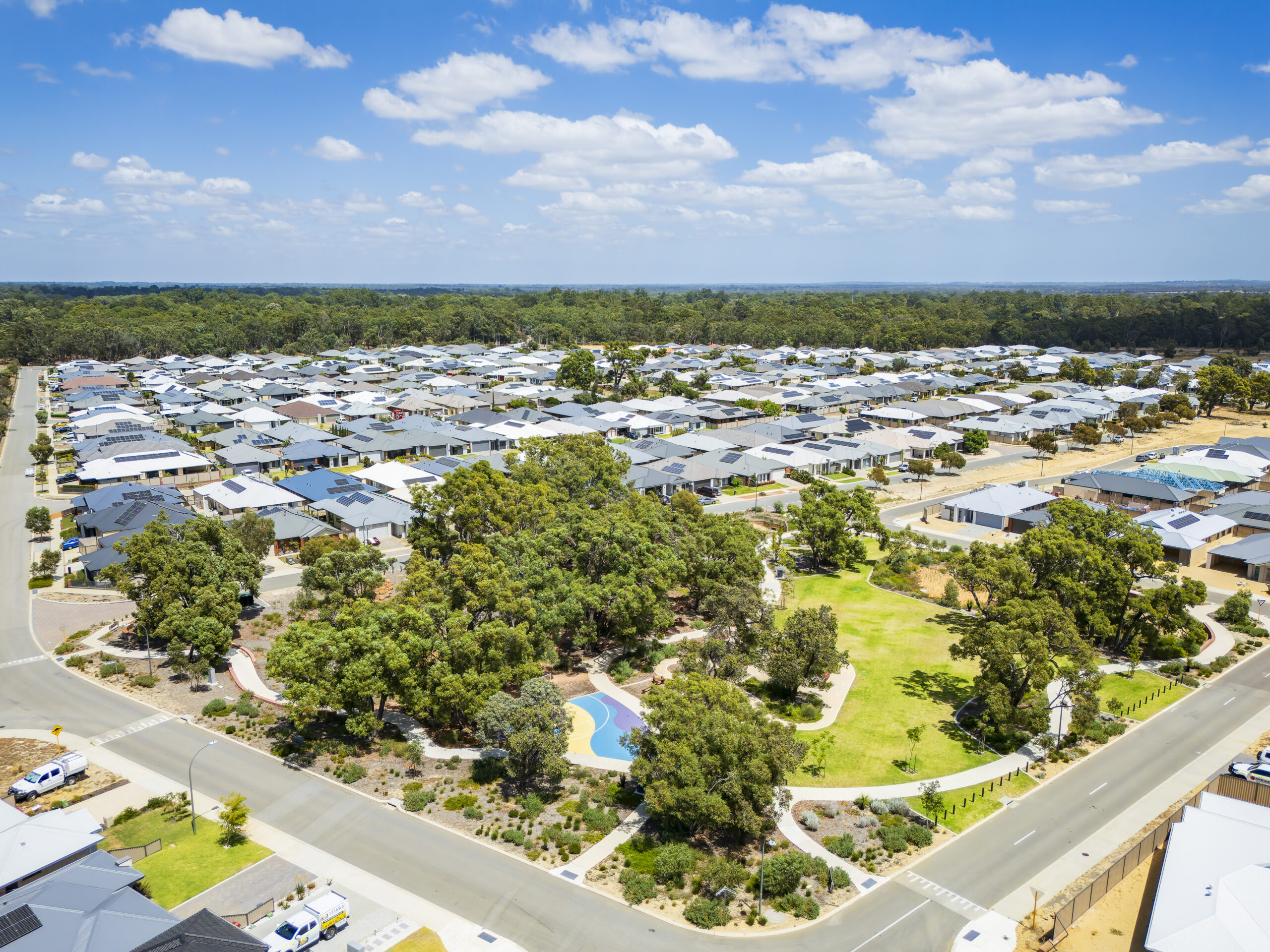Aerial view of Whitby Town estate with homes and native bushland