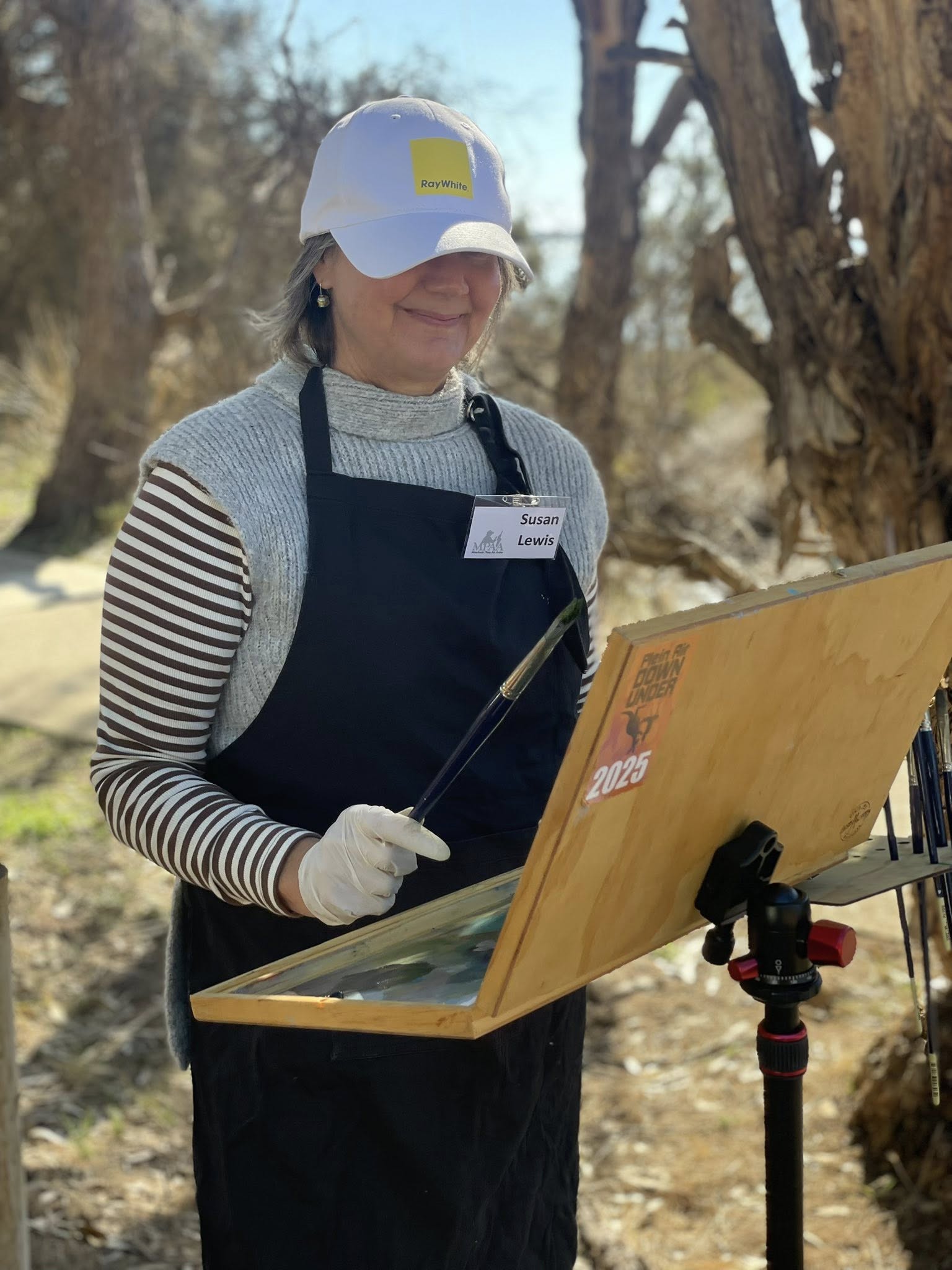 Artist painting outdoors at Plein Air Down Under